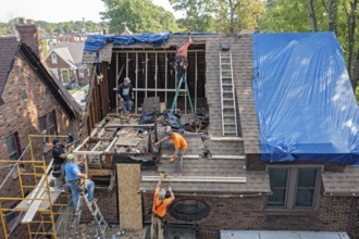 Detroit, Michigan, Workers rebuild the attic of a house damaged when a storm blew down a 15-ton,