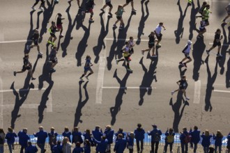 Marathon runners and their shadows at the 50th BMW Berlin Marathon 2024 on 29 September 2024