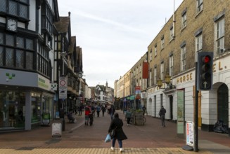 People shoppers walking along pedestrianised town centre street, Tavern Street, Ipswich, Suffolk,