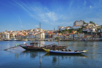 View of Porto city and Douro river with traditional boats with port wine barrels from famous