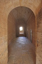 Interior view of the corridor of the Romanesque abbey Le Thoronet, archway, door, open, passage,