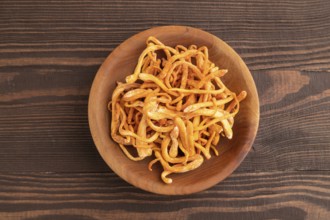 Fresh Cordyceps militaris mushrooms on brown wooden background. Top view, flat lay, copy space