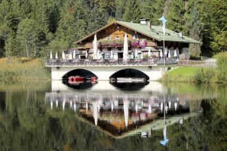 The picturesque Pflegersee lake near Garmisch, with the mountain inn in the background