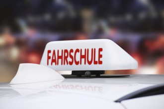 Close-up of a driving school sign on the roof of a car in Germany