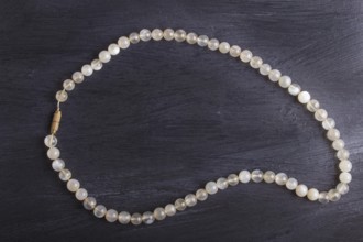 Agate colored beads on a black background. top view, close up