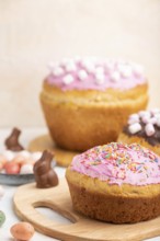 Homemade glazed and decorated easter pies with chocolate eggs and rabbits on a white concrete