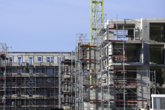 Photo of a large construction site in a newly developed residential area. Several apartment