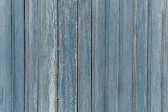 Garage door boards stained blue with worn paint. Brittany France