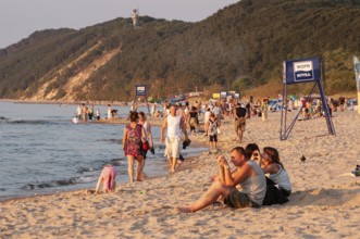 People on the beach in evening light in Miedzyzdroje, Western Pomerania, Baltic Sea, Poland, East