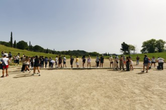 Tourist group in the stadium, birthplace of the Olympic Games, Olympic Stadium, ancient Olympia,