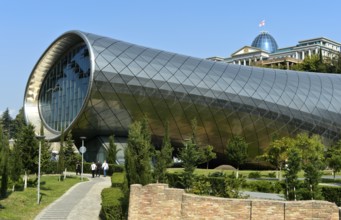 Futuristic theatre building and exhibition hall in Rike City Park, architect Studio Fuksas, behind