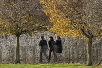 Students in park in autumn at the Oxford University, Oxfordshire, England, UK