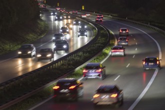 Night traffic on a four-lane motorway with fast vehicles and shining headlights, Rems-Murr