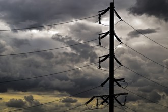 Electricity pylons and storm clouds