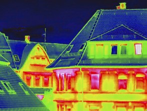 Apartment block, facade of a residential building with windows. Thermal image or thermography,