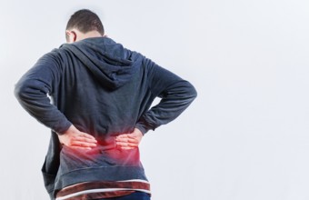 Back view of person with back ache isolated. Lumbar problems concept. Male person with spine