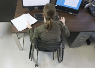 Young woman in a wheelchair at her workplace, Berlin, 18/01/2017