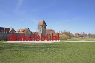 View of historic town wall with town fortifications and Bäuerlinsturm and inscription Dinkelsbühl,