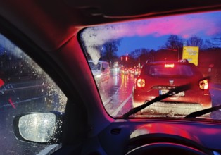 Driving in heavy traffic and rain at dusk, Witten, North Rhine-Westphalia, Germany, Europe