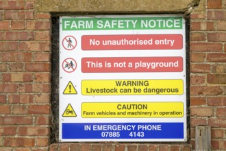 Farm Safety Notice sign on farmyard wall, Boyton, Suffolk, England, UK