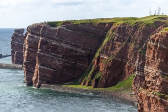 Red coloured sandstone, steep cliff coast of the offshore island of Heligoland, home of the