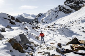 Mountaineers on the hiking trail to Ramoljoch with snow in autumn, in the morning light, Ötztal