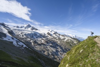 Mountaineer on a hiking trail, view of high alpine mountain landscape, summit of Aiguille de