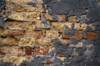 Grey plaster crumbling from a dilapidated brick wall, Venice, Veneto, Italy, Europe