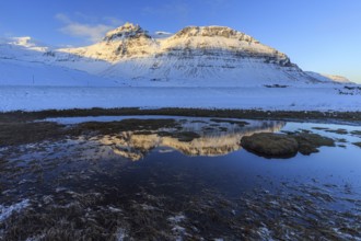 Mountains reflected in fjord at low tide, snow, winter, morning light, near Kirkjufell,