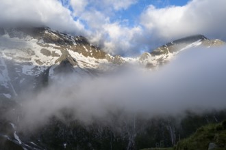 Cloudy mountain landscape with summit Hochsteller and Griesferner with snow and glacier, Berliner