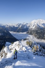 Tourist on a hiking trail, Snow-covered summit of the Jenner with viewing platform in autumn, view