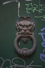 Old door knocker, head and ring on a front door, historic centre, Genoa, Italy, Europe