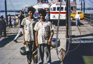 Two boys on board a car ferry crossing the Rio Magdalena river to Barranquilla, Colombia, South