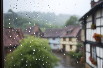 AI generated raindrops tracing paths down a large window with village with half timbered houses in