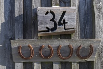 Horseshoe under a house number on a barn, Bavaria, Germany, Europe