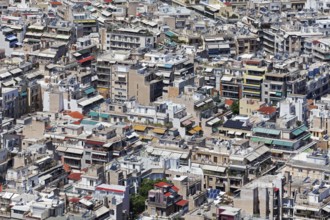 View of densely built-up metropolis, sea of houses without greenery, colourful awnings, symbolic