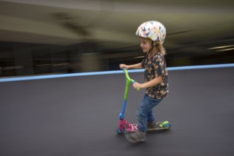 Little boy, 5 years, blond, helmet, helmet, riding on scooter, scooter, skater track, playground,