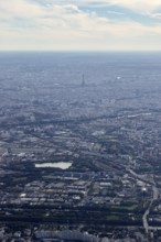 Aerial view of an urban landscape under a slightly cloudy sky, flight, aerial view