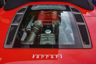 View of transparent bonnet and engine of sports car Ferrari F 430 F430 Spider in colour Corsa Rosso