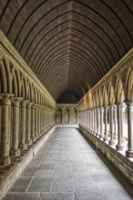 Long cloister with vaulted ceiling and elegant stone arches, Le Mont-Saint-Michel