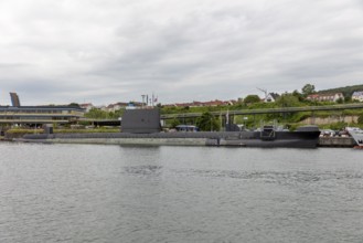 Submarine at the harbour with city in the background under a cloudy sky, Rügen