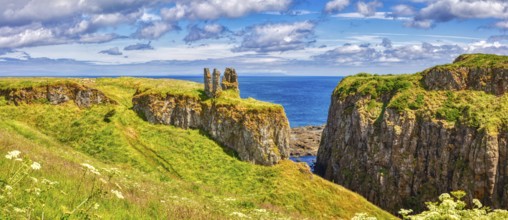 A medieval castle ruin on cliffs overlooking the sea under a blue sky, Dunseverick Castle