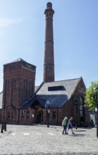 Historic brick building with tall chimney in sunny weather, Liverpool