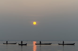 Fishermen on the Vembanad Lake at sunrise, Kerala, South India, India, Asia