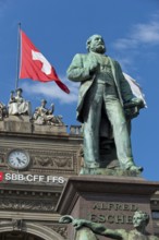 Swiss flag behind monument to Alfred Escher, Swiss politician, business leader and railway pioneer,