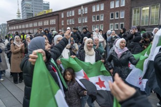 Syrian woman celebrate the end of the Assad regime after the change of power in Syria at a rally on