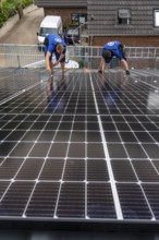 Installation of solar modules on the roof of a barn on a farm, over 240 photovoltaic modules are