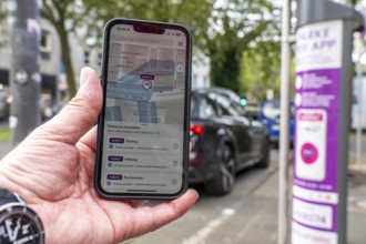 Parking in public spaces via parking app, EasyPark, here in Bochum, parking ticket machine where