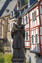 Monreal, idyllic half-timbered village in the Elz valley, figure of Nepomuk, the bridge saint, in