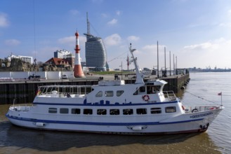 Skyline of Bremerhaven, Atlantic Sail City Hotel skyscraper, excursion boat Geestemünde, leaving